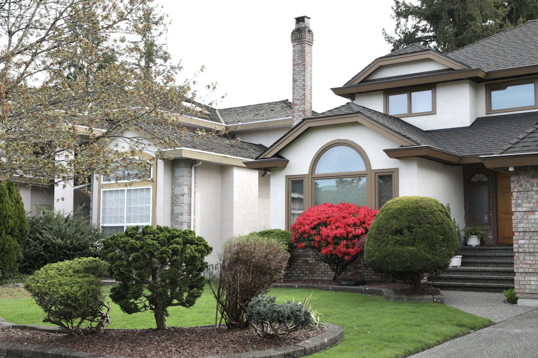 Front yard with manicured shrubs and flowers
