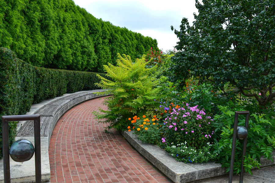 Brick path lined with flowering garden beds